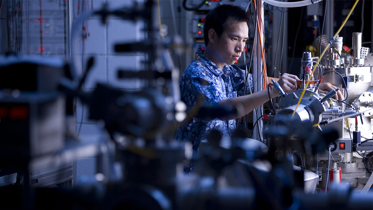 A researcher in a lab, working with complex machines